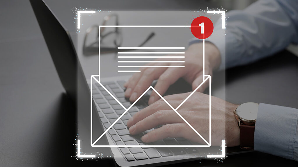 3.	Ikona email poruke i obaveštenje o pristigloj poruci koje prekriva ruke osobe koja radi na laptopu.
